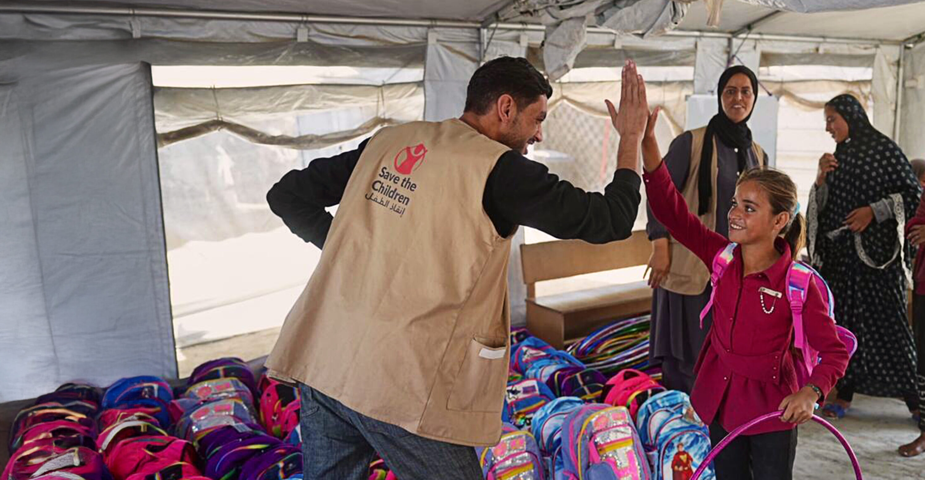 20251219 Children receiving their school bags and kits from Save the Children header
